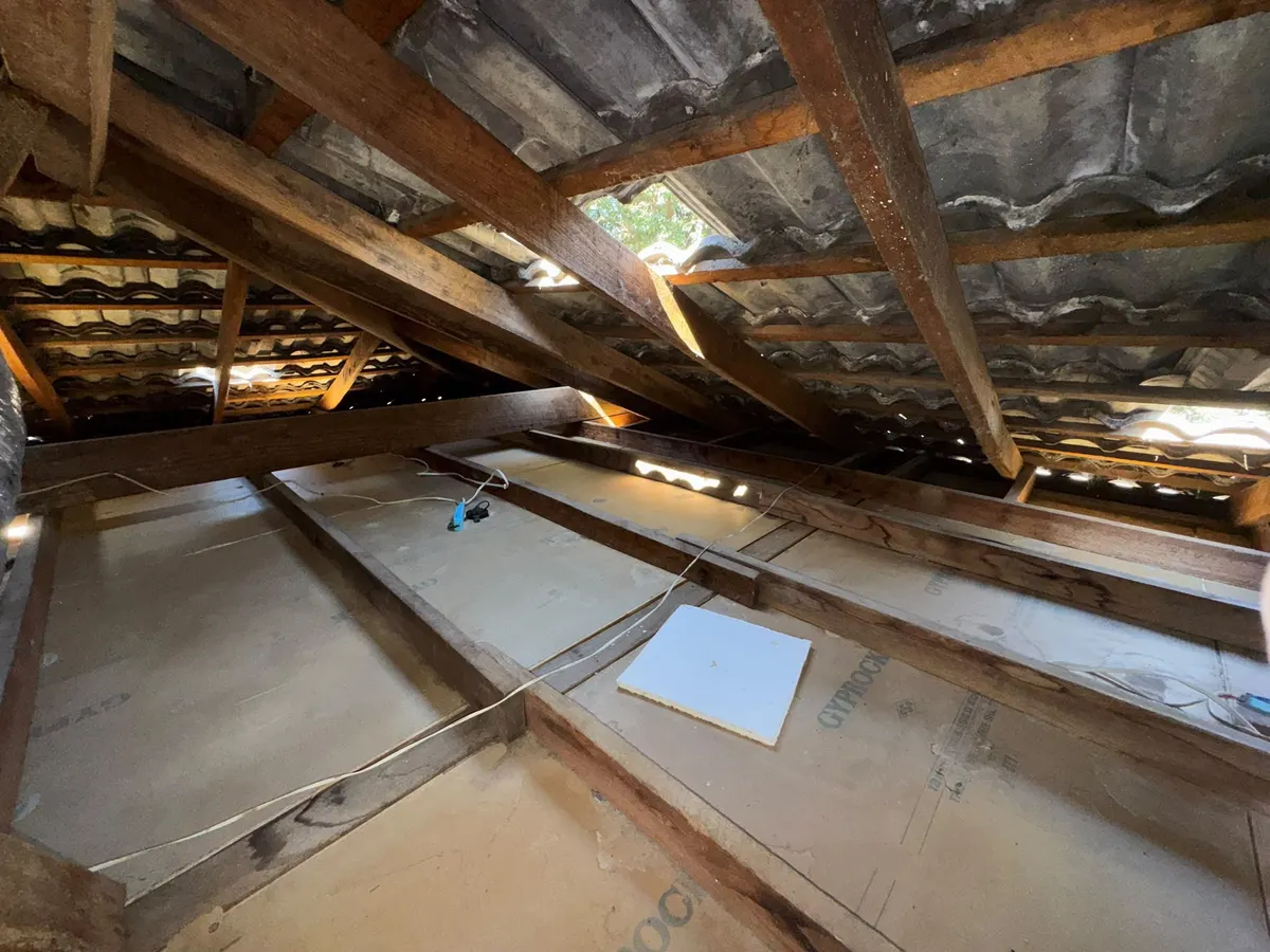 Roof cavity after vacuum removal, cleared down to the ceiling and joists (photo 2 of 7)