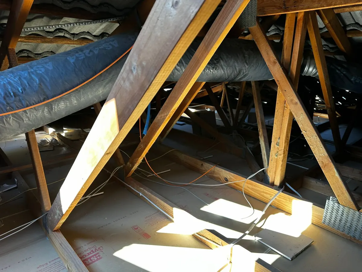 Roof cavity after vacuum removal, cleared down to the ceiling and joists (photo 5 of 7)