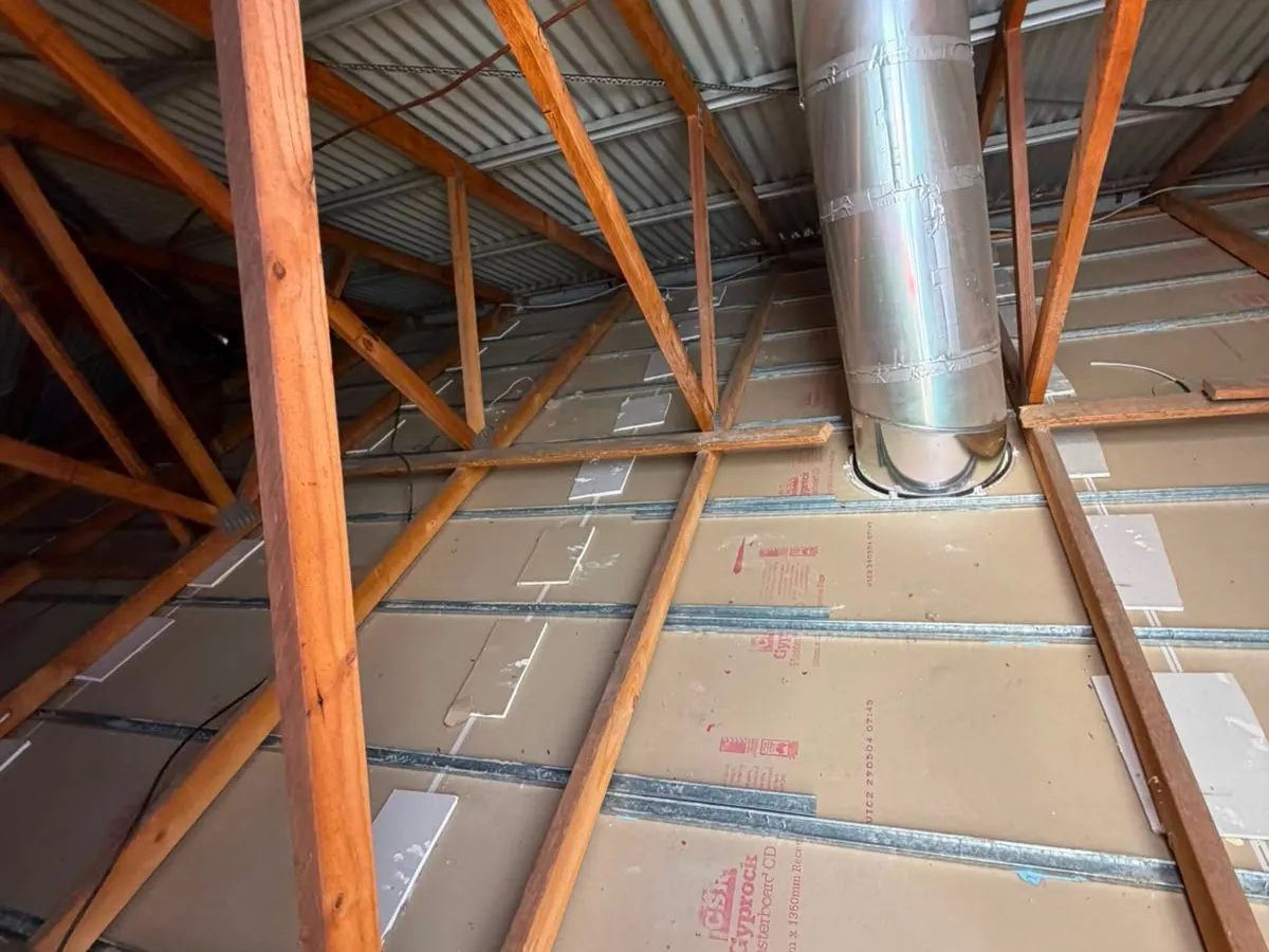Roof cavity after vacuum removal, cleared down to the ceiling and joists (photo 6 of 7)